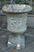 A reconstituted stone garden urn.