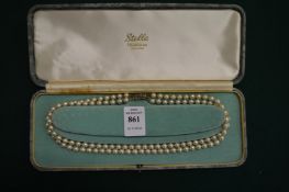 A boxed pearl necklace.