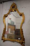 A gilt wood rococo style wall mirror.