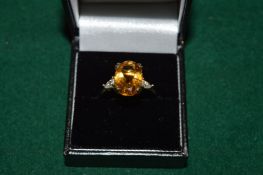 A gilded silver ring set with a 5ct citrine, with certificate.