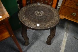 An Indonesian carved hardwood circular occasional table.