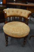 A Victorian small horseshoe shaped and upholstered bedroom chair.