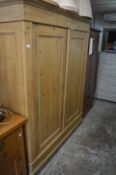 A large 19th century pine two door armoire.
