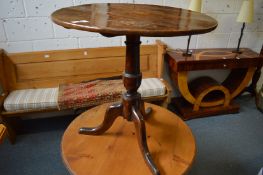 A 19th century oak tilt-top tripod table.