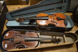 Two cased violins.
