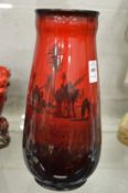 A Royal Doulton flambe glazed vase decorated with Arab scenes.