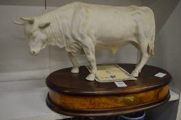 A good Capodimonte porcelain model of a bull mounted on a wooden plinth.
