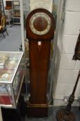 A walnut grandmother clock.