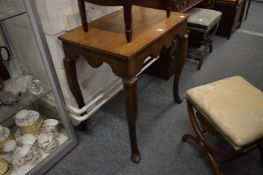 An oak side table on cabriole legs.