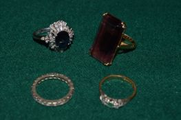 An 18ct yellow gold ring, an 18ct white gold ring and two other rings.