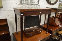 A mahogany rectangular fold-over card table.