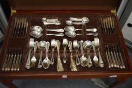 A floor standing 12 place bead pattern canteen of cutlery.