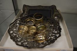 Silver napkin rings, silver photograph frame and other items.