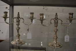 A pair of silver twin branch candelabra.