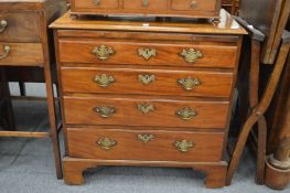 A George III mahogany bachelors chest with brushing slide above four graduated long drawers on