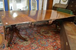 A very good mahogany twin pillar extending dining table with drop-flap ends.