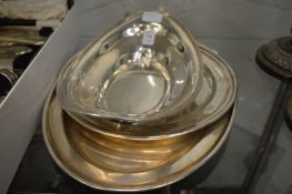 A plated dish and two trays.