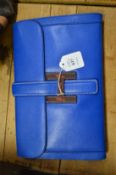 A ladies blue leather clutch bag.