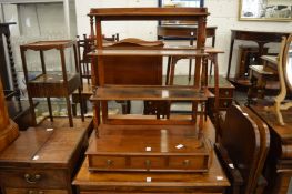 A mahogany tabletop open bookcase with three small drawers to the base.