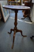 Two mahogany tripod tables.