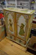 An Indian decoratively painted miniature wardrobe.