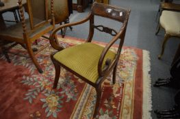 A 19th century mahogany dining chair with arms and three matching side chairs.