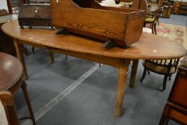 A good 19th century pine oval shaped dining table on chamfered square supports.