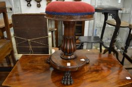 A good 19th century mahogany revolving music seat with carved paw feet.
