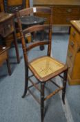 A 19th century mahogany and cane seated correction chair.