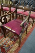 A Regency style dining chair with arms.