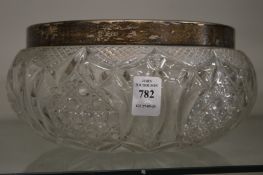 Cut glass bowl with silver rim.
