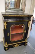A 19th century ebonised and ormolu mounted single door pier cabinet.