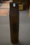 A large brass shell case.