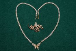 A 9ct gold and pearl leaf shaped brooch together with a pearl necklace mounted with a butterfly