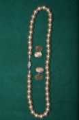A pair of silver gilt cufflinks and a pearl necklace.