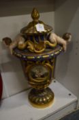 Continental gilt decorated porcelain vase and cover, the handles modelled as fish tailed cherubs,