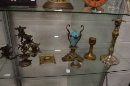 An ornate gilt metal candelabra and other decorative metal ware.