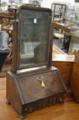 A good 18th century walnut toilet mirror with original plate glass, above a fall flap enclosing a