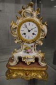 A French porcelain mantel clock on gilt wood stand.