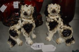 A pair of small Staffordshire black and white spaniels.
