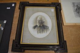 Photographic print of an elderly gentleman in a decorative frame.