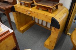 An Art Deco style blonde wood desk.