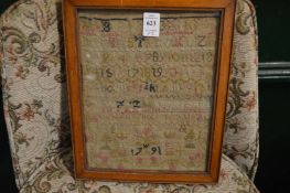 A small framed and glazed sampler dated 1791 together with a silk work sailing picture.