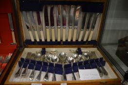 An oak cased canteen of cutlery (lacking one fork).