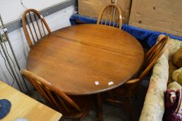 An Ercol drop-leaf kitchen table with set of four Ercol chairs, two with arms.
