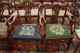 Two Georgian style dining chairs with arms.