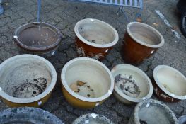 Seven glazed plant pots.