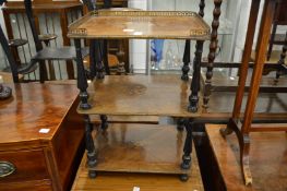 A Victorian marquetry inlaid three-tier whatnot.