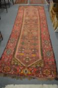 A good Persian hall carpet, red ground with stylised decoration, 350cm x 124cm.