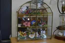 A terrarium housing porcelain butterflies.